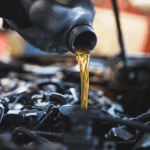 Close-up of a service technician performing an oil change service at the service center.