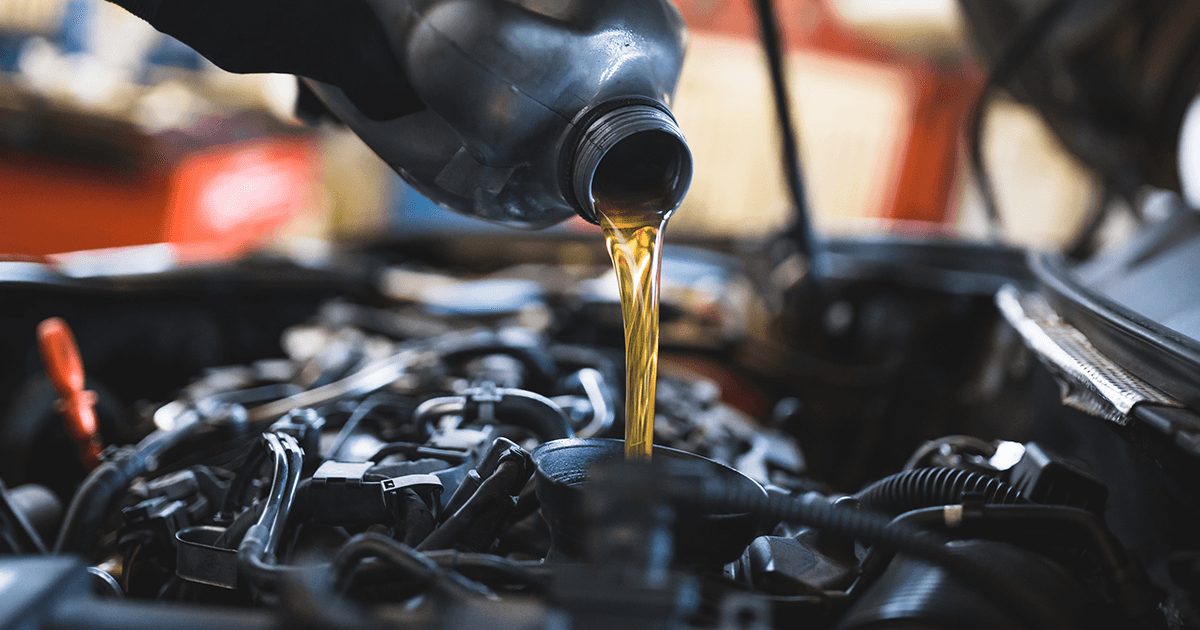 Close-up of a service technician performing an oil change service at the service center.