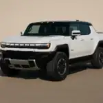 White Hummer EV on a sandy surface