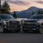 Lakeside SUVs at dusk with mountains