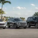 SUVs by the coast with luxury backdrop