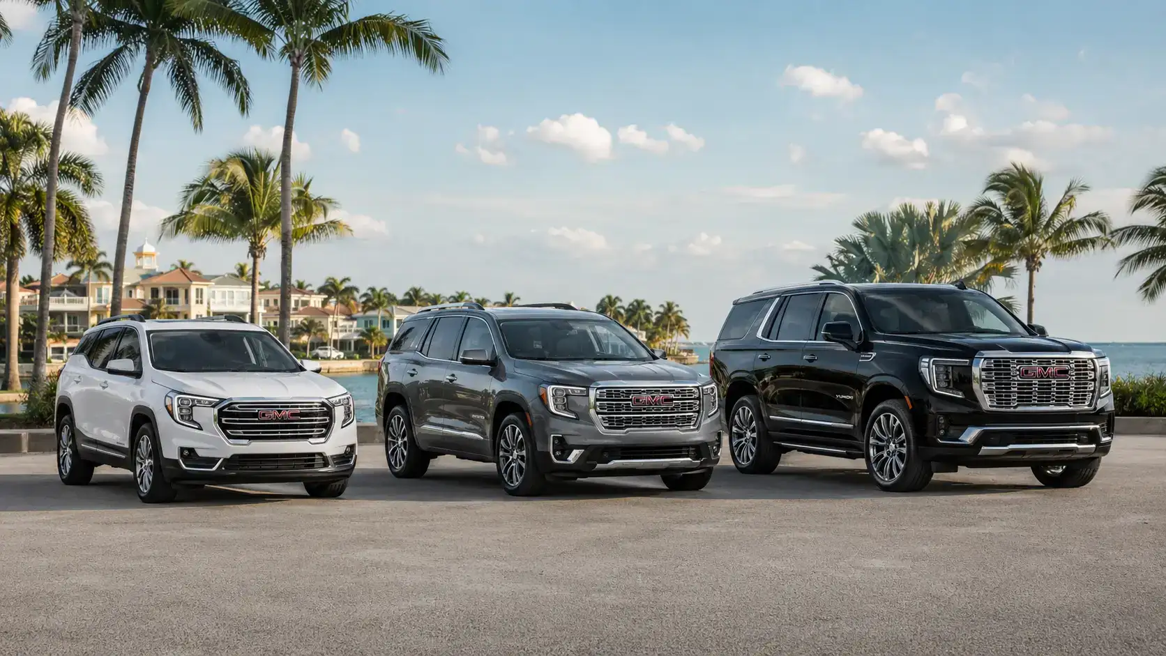 SUVs by the coast with luxury backdrop