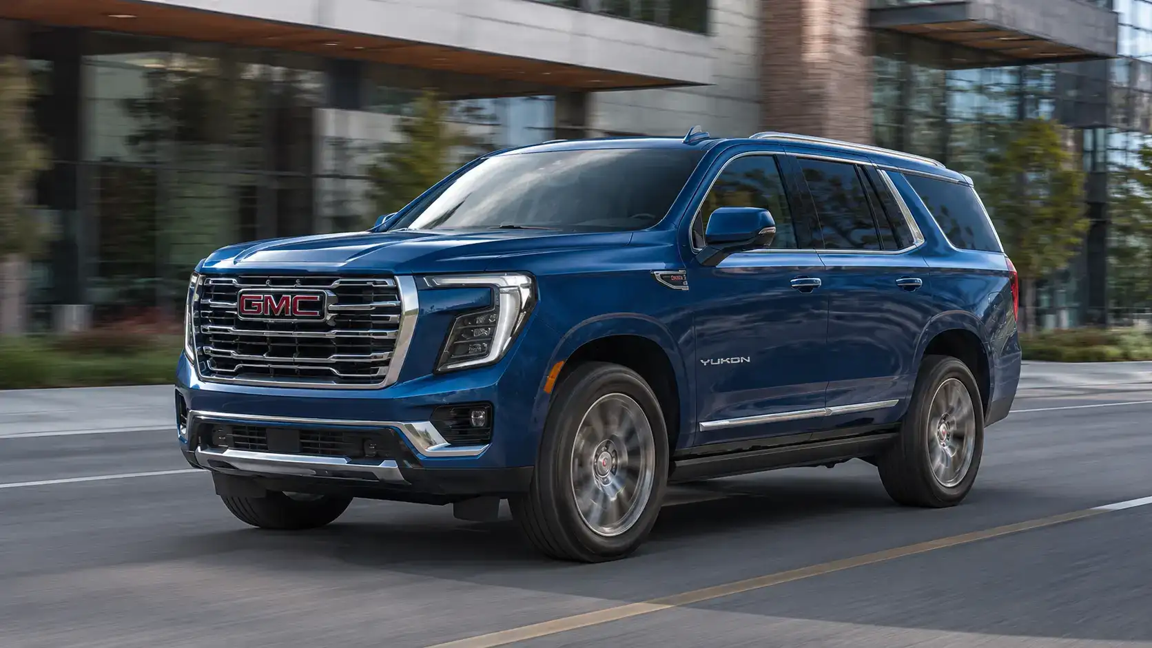 Blue GMC Yukon Driving Downtown
