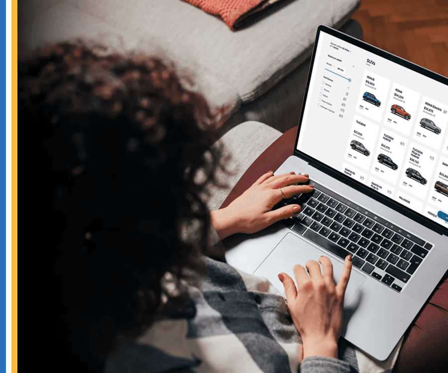 Woman on laptop looking at cars