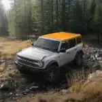 2026 Ford Bronco Badlands with Orange Fury Color Roof traversing offroad in the mountains