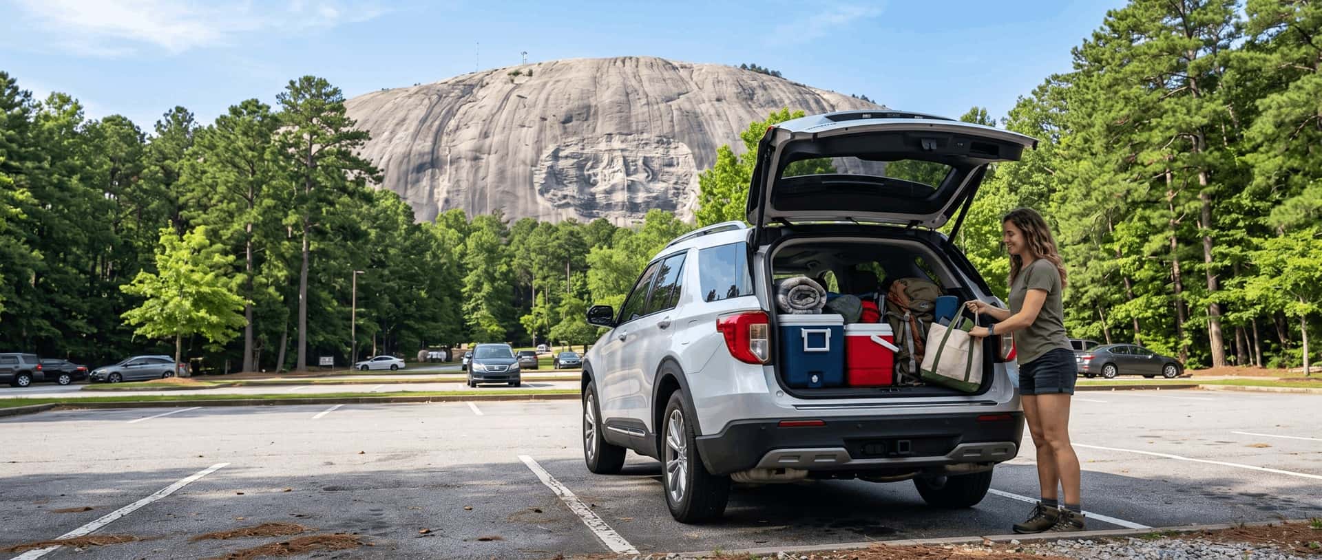 2026 Ford Explorer parked at Stone Mountain Park with the granite dome visible in the background on a clear summer morning