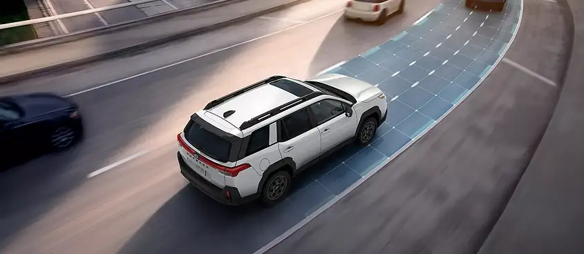 Overhead view of a white 2026 Subaru Forester using adaptive cruise control to keep distance behind traffic