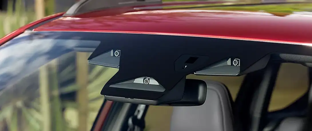 Close-up of the Subaru EyeSight dual-camera unit mounted at the top of the windshield