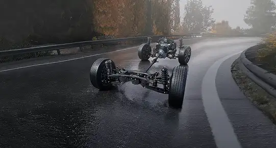Exposed Subaru Symmetrical All-Wheel Drive chassis and drivetrain on a wet road