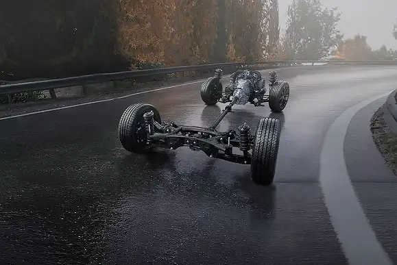 Exposed Subaru Symmetrical All-Wheel Drive chassis and drivetrain on a wet road
