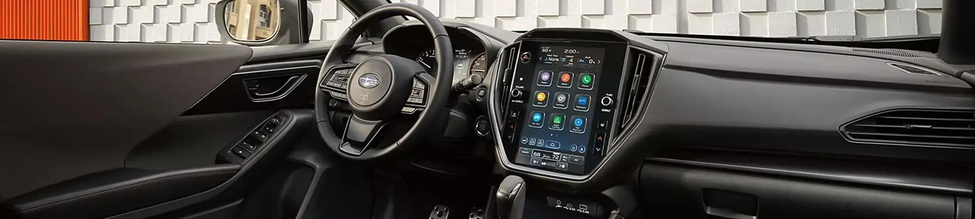 Front cabin and dashboard of the 2026 Subaru Impreza with vertical touchscreen and red stitching