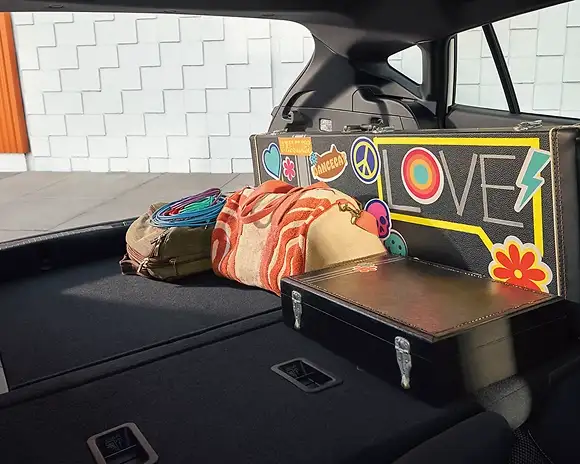 Rear cargo area of the 2026 Subaru Impreza loaded with a retro suitcase and travel gear
