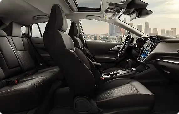 Front seats of the 2026 Subaru Impreza with a city skyline beyond the windshield