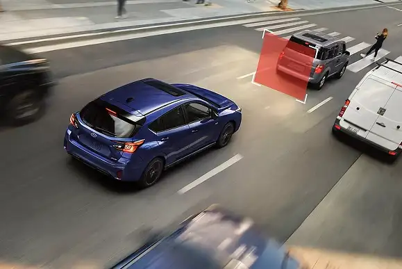 Overhead view of a blue 2026 Subaru Impreza with a red pre-collision braking zone highlighting a vehicle ahead at a crosswalk