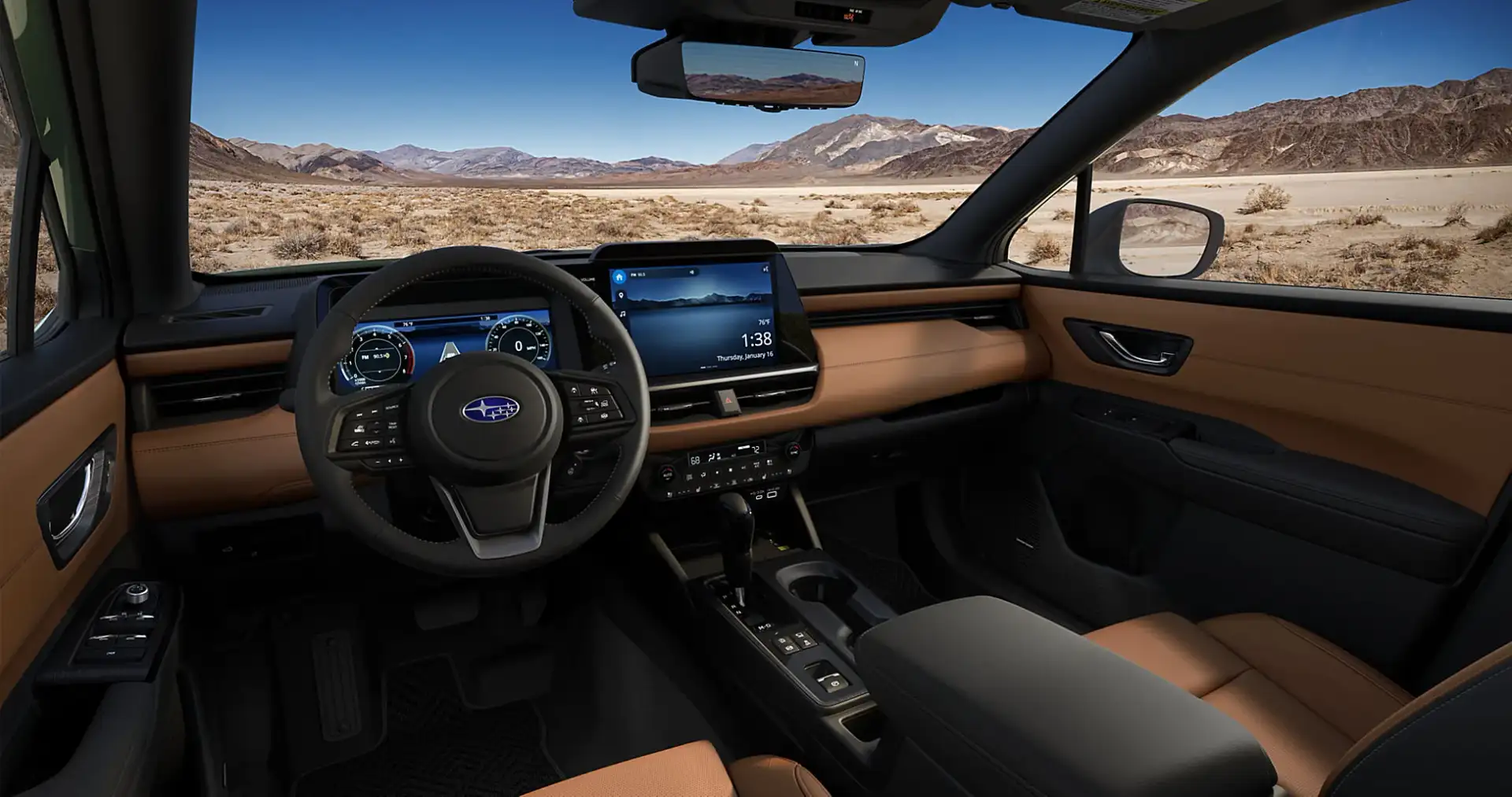 The redesigned 2026 Subaru Outback dashboard with a large horizontal touchscreen, digital gauge cluster, and physical climate controls, desert visible through the windshield