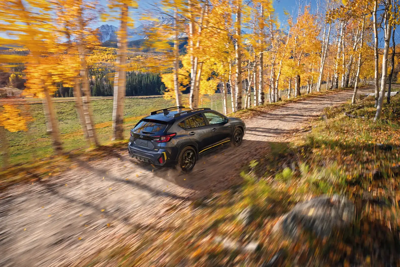A Subaru Crosstrek with standard all-wheel drive on a graded-dirt mountain road, the kind of drive Findlay Subaru of Las Vegas buyers make on the weekend