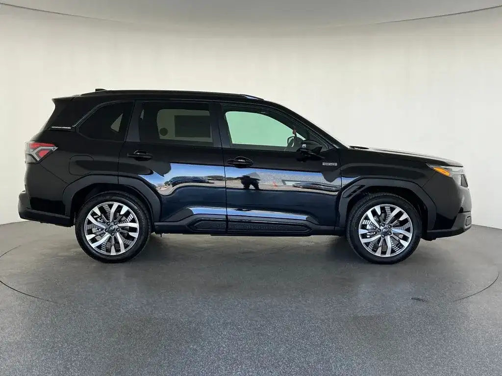 Subaru Forester in black, driver-side profile, photo 2 of 12