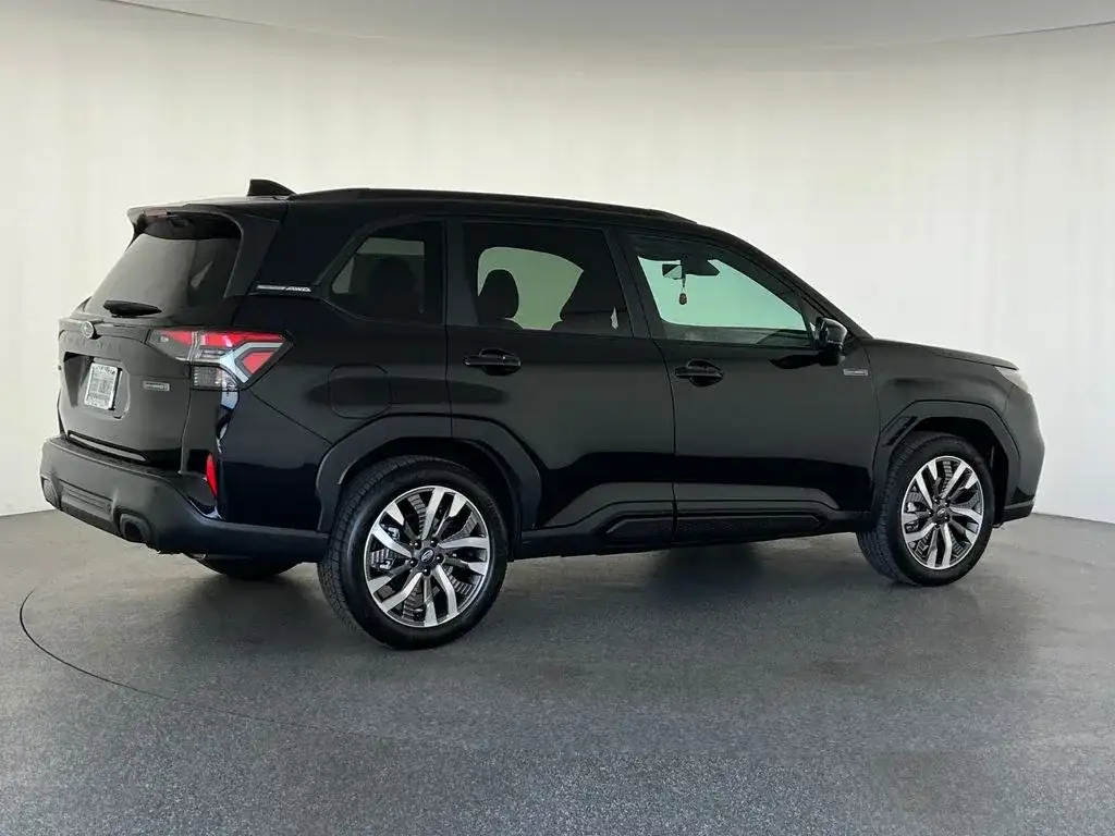 Subaru Forester in black, rear three-quarter view, photo 3 of 12