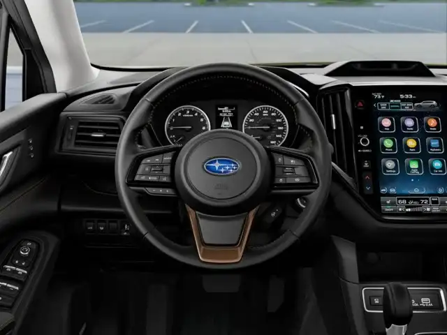 Driver's cockpit of the 2026 Subaru Ascent with steering wheel, gauges and touchscreen