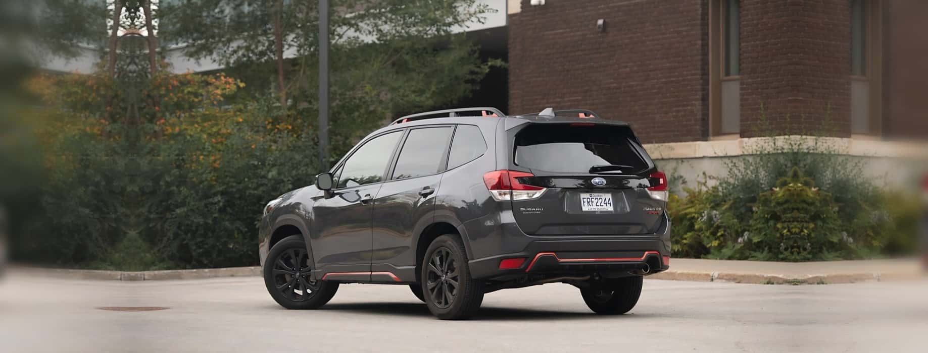 A grey Subaru Forester Sport with black wheels parked on a paved lot, the kind of used Subaru that turns up on the lot in Las Vegas