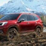 Red 2022 Subaru Forester on Muddy Trail