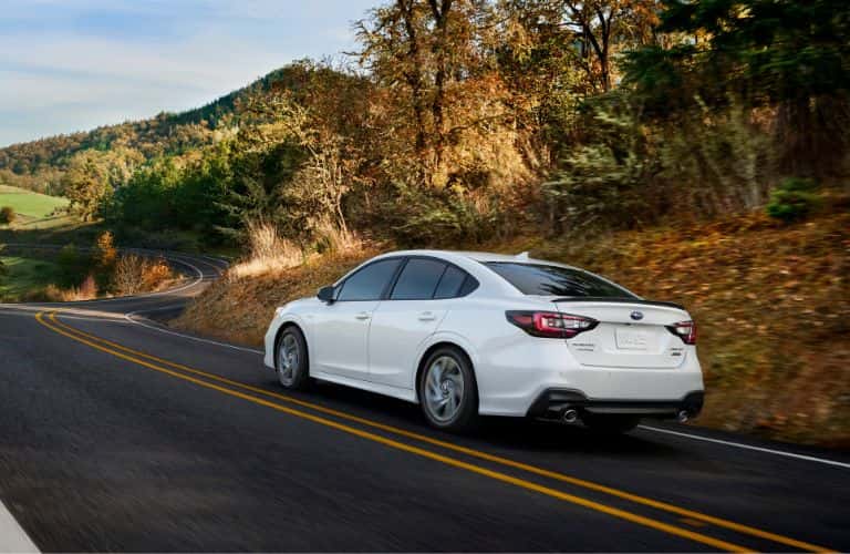 White 2023 Subaru Legacy Rear Exterior on a Country Road
