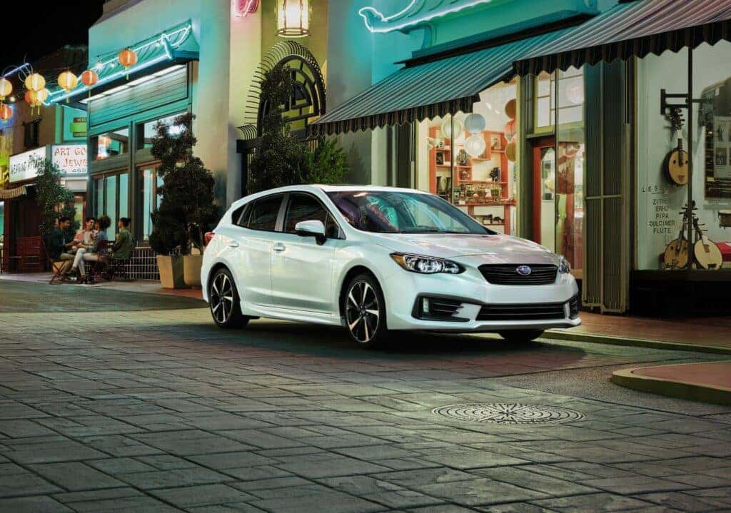 2023 Subaru Impreza Hatchback parked downtown at dusk