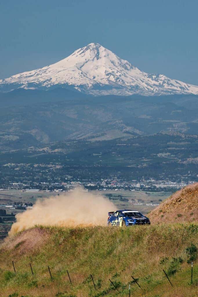 Subaru Rally Car drifts around a tight curve, throwing up dust as it traverses the rough terrain of the Oregon Trail