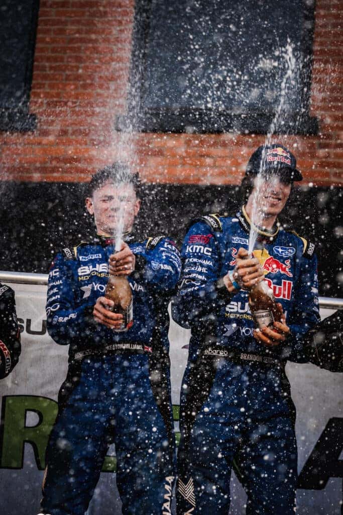 Subaru Motorsports USA driver Brandon Semenuk and co-driver Keaton Williams had a spectacular victory at the 2023 Oregon Trail Rally and continued their winning streak in the 2023 American Rally Association (ARA) championship with a fourth win out of four events so far in the season. The two guys celebrate with champagne bottles overflowing