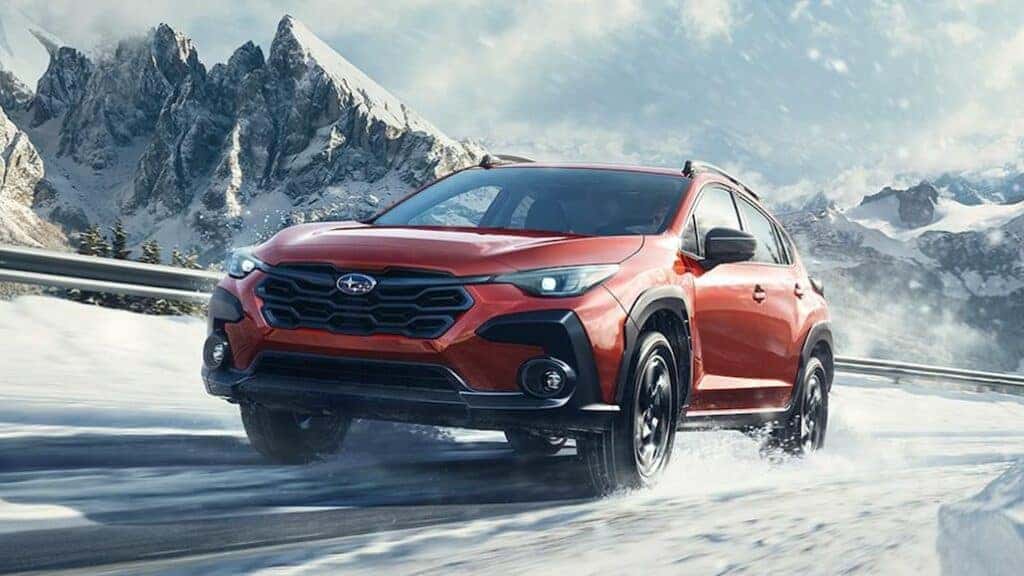 Subaru Crosstrek Driving Through Snowy Mountains Front 3/4 View