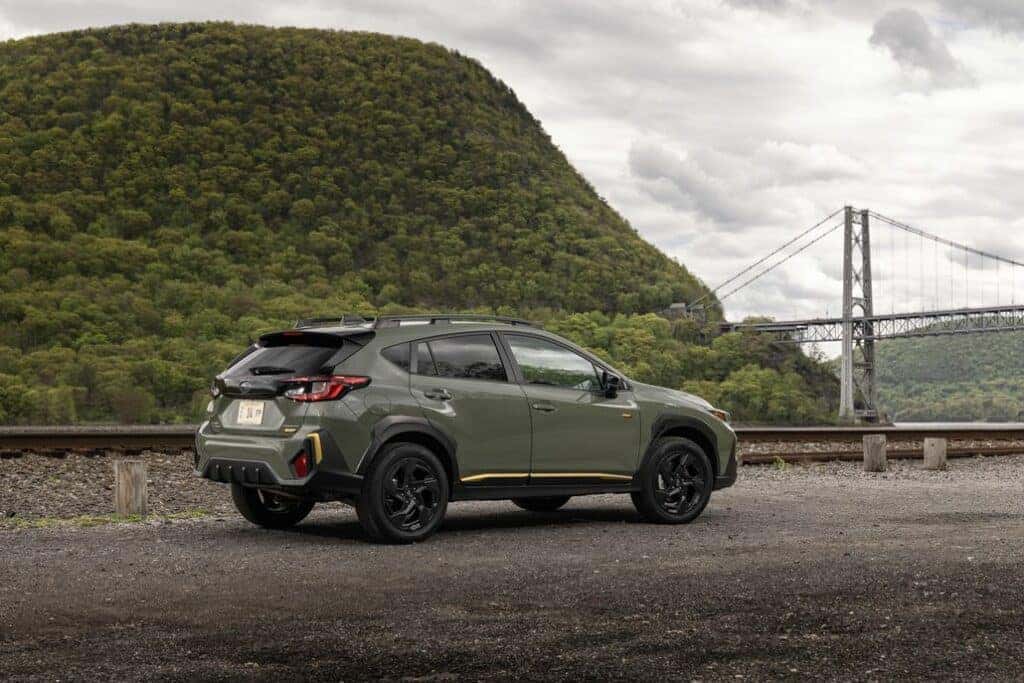 Subaru Crosstrek Parked Rear 3/4 View in Front of a Bridge and Hill