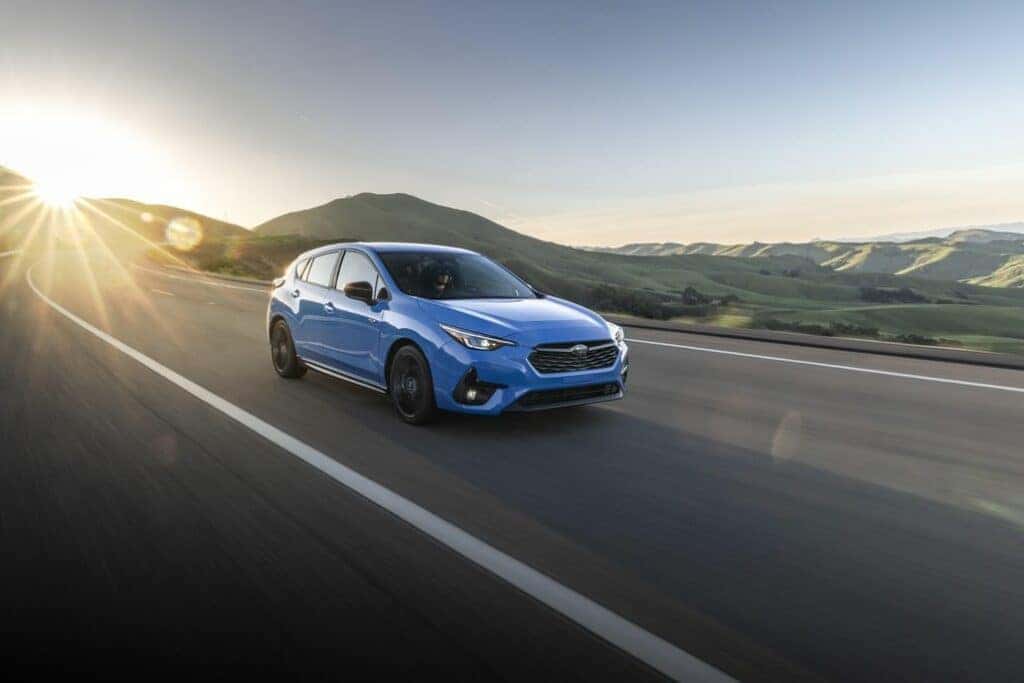 Subaru Impreza Driving on a Highland Road Front 3/4 View
