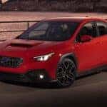 Ignition Red 2023 Subaru WRX driving over bridge