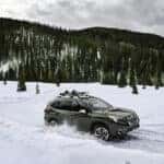 2023 Forester driving through snowy mountains