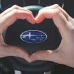 Subaru Love Promise - Heart Hands around the Subaru Logo on a Steering Wheel