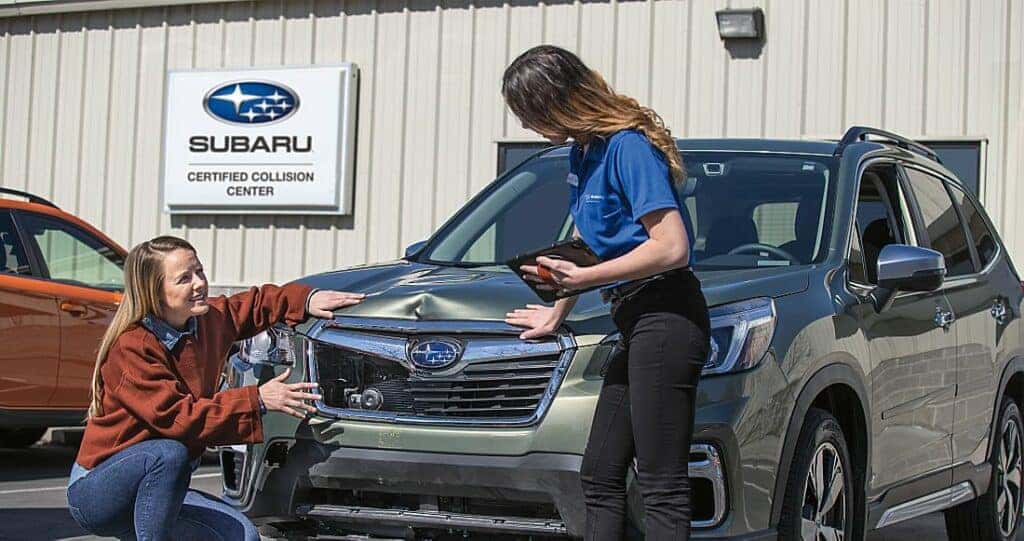 Subaru with front end damage being seen at a service and body work center.