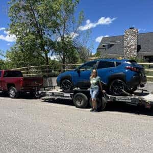 Beth's Geyser Blue 2024 Subaru Crosstrek Wilderness on a trailer, being delivered to her home in Hailey, Idaho