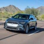 The Fierce Subaru Solterra EV Driving Down The Highway, With Gorgeous Mountains In The Background
