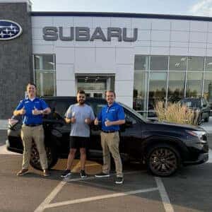 Christopher, from Ketchum, Idaho, with his Crystal Black Silica 2025 Subaru Forester Sport in front of the Magic Valley's #1 Volume Automotive Retailer - Twin Falls Subaru in Twin Falls, Idaho.