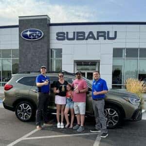 Cody & Britteny, from Filer, Idaho, with their Autumn Green Touring 7-Passenger and Product Specialist Tyler Morrison in front of the Magic Valley's #1 Volume Automotive Retailer - Twin Falls Subaru in Twin Falls, Idaho.