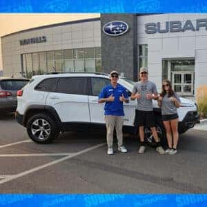 Aleena & Avery, from Oakley, Idaho, with their Bright White Clear Coat 2015 Jeep Cherokee Trailhawk with their Product Specialist Cory Budden in front of the Magic Valley's #1 Volume Automotive Retailer - Twin Falls Subaru.