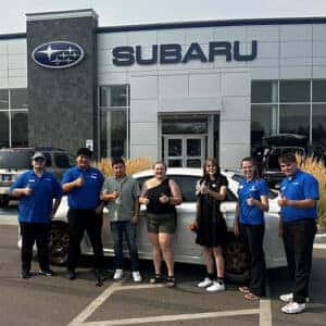 Alvaro, from Buhl, Idaho, with her used Satin White Pearl 2013 Subaru Impreza WRX with Product Specialist Tony Juarez.