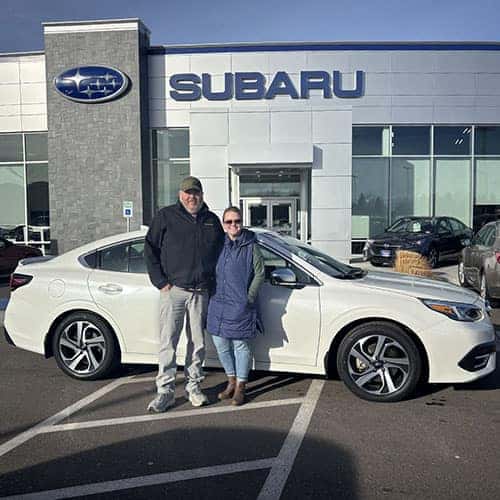 Dusty & Angie from Kimberly, Idaho with their Crystal White Pearl 2020 Subaru Legacy Touring XT in front of Twin Falls Subaru, the Magic Valley's #1 Volume Automotive Retailer in Twin Falls, Idaho