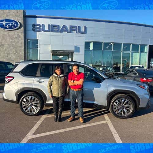 Gloria & Serapio from Jerome, Idaho with their Silver Metallic 2025 Subaru Forester Touring in front of the Magic Valley's #1 Volume Automotive Retailer - Twin Falls Subaru in Twin Falls, Idaho