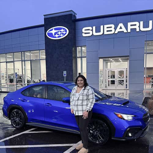 Jerome, Idaho driver Michelle, from Jerome, Idaho, with her World Rally Blue 2024 Subaru WRX Limited, assisted by Purchase Advisor Paola Orozco