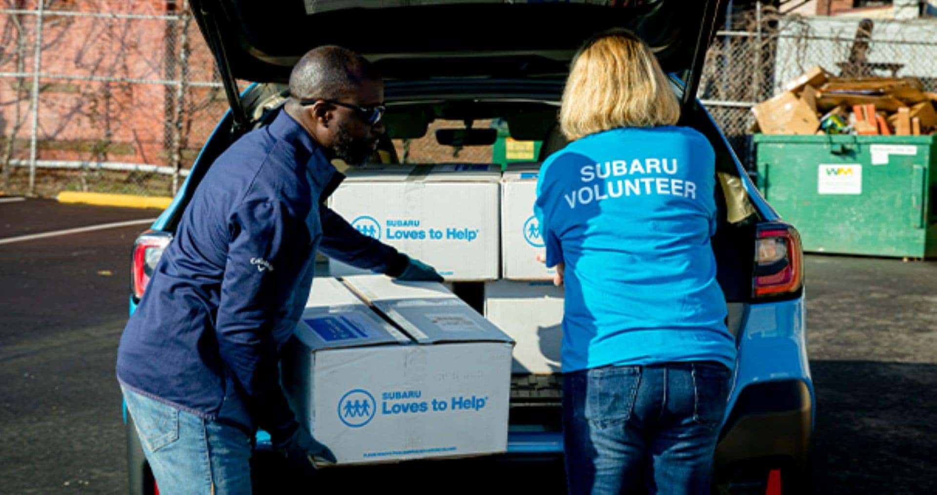 Dilligent And Supportive Subaru Loves Volunteers Unpacking The Car's Trunk