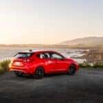 2026 Subaru Impreza Pure Red next to a coastline