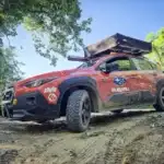 Modified 2025 Subaru Crosstrek Wilderness driving on a trail road