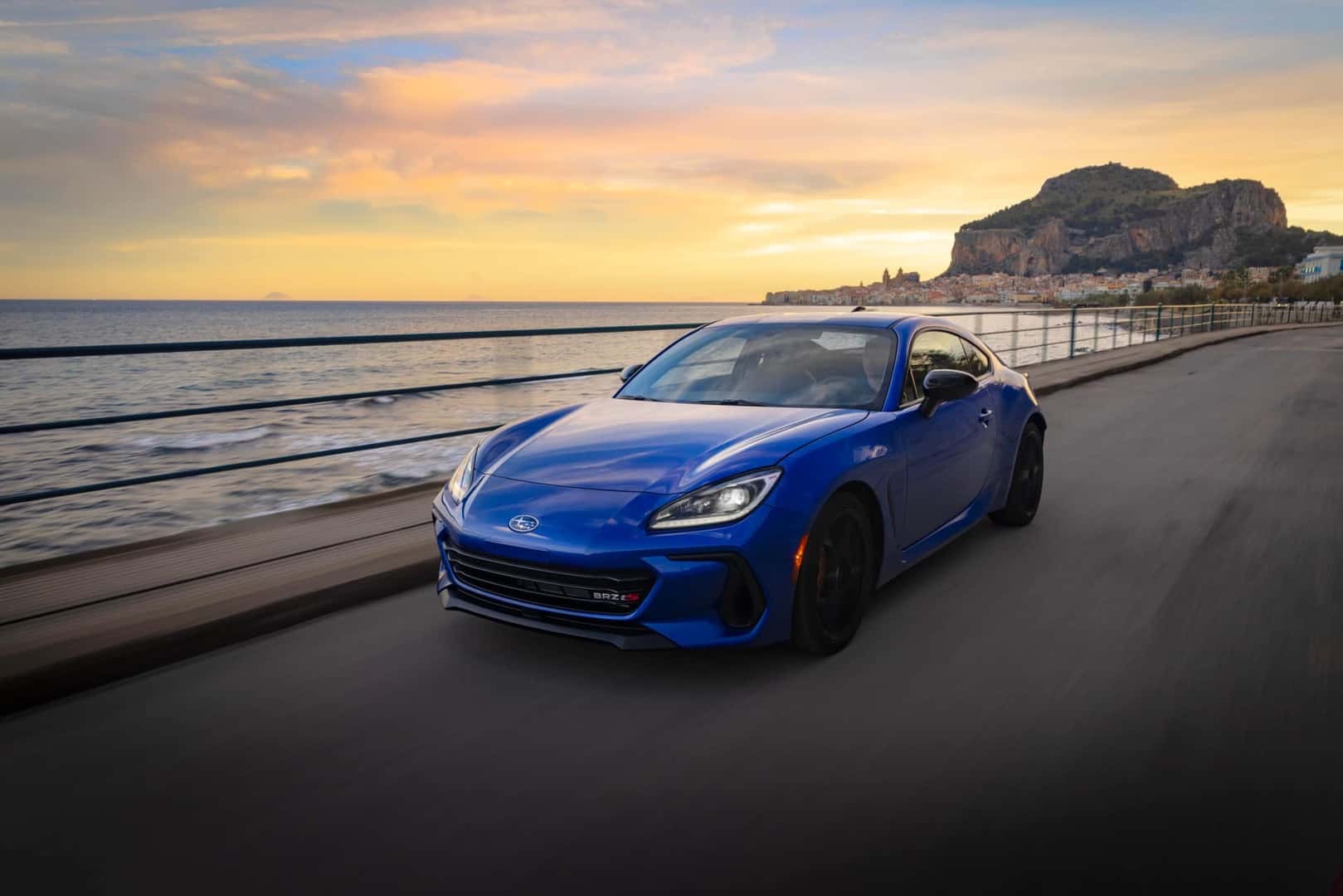The Captivating 2026 Subaru BRZ, Speeding On The Highway Past A Glittering Sea And A Beautiful Masterpiece Of A Sunset