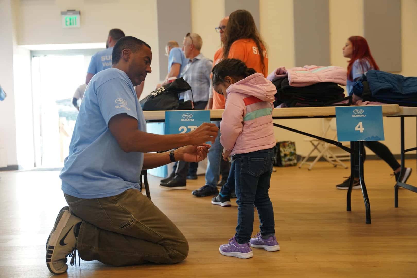 Subaru Employee Helping Kid With Coat